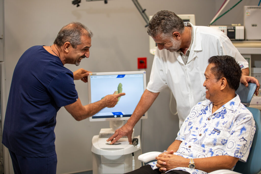 doctor and patient looking at computer model of teeth of patient