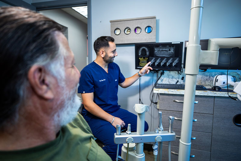 doctor point at x-ray showing patient