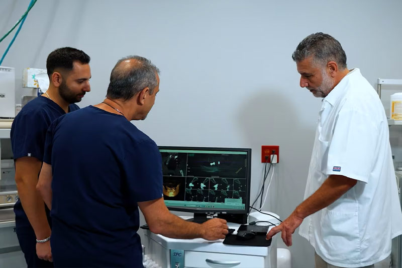 dentist looking desktop screen with x-rays
