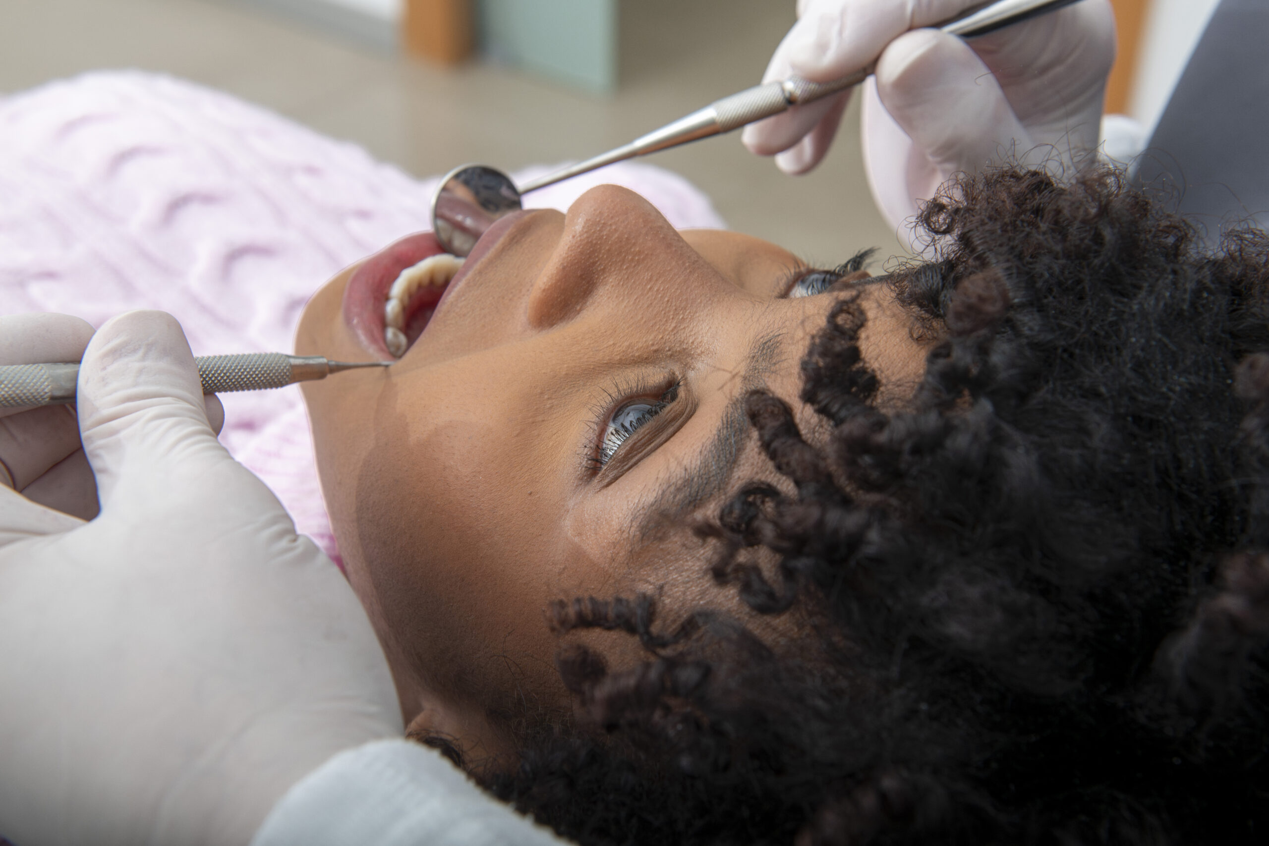 crown-lengthening-dentist-examining-patient-s-teeth-in-dental-clinic-adhp-fallbrook-