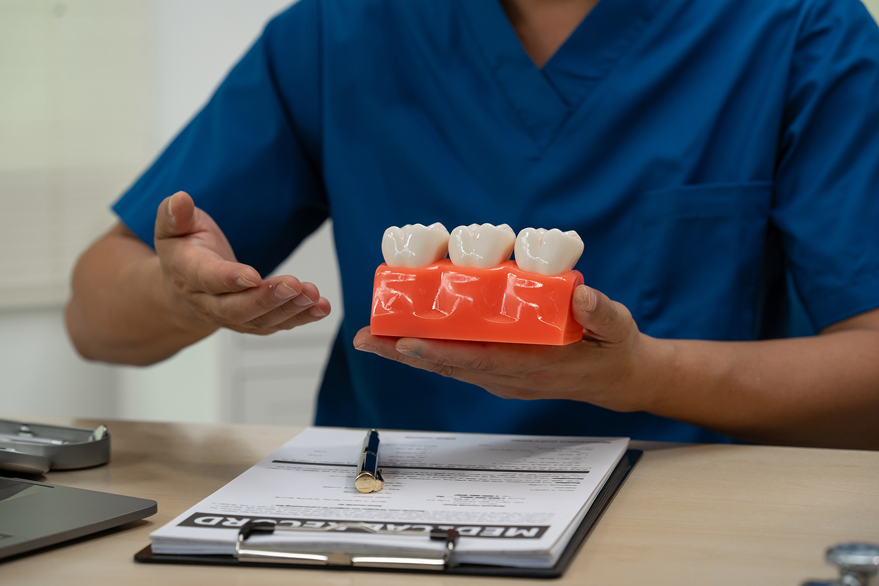 a-male-doctor-sits-working-at-the-table-in-dentist-2026-03-20-02-25-40-utc 1