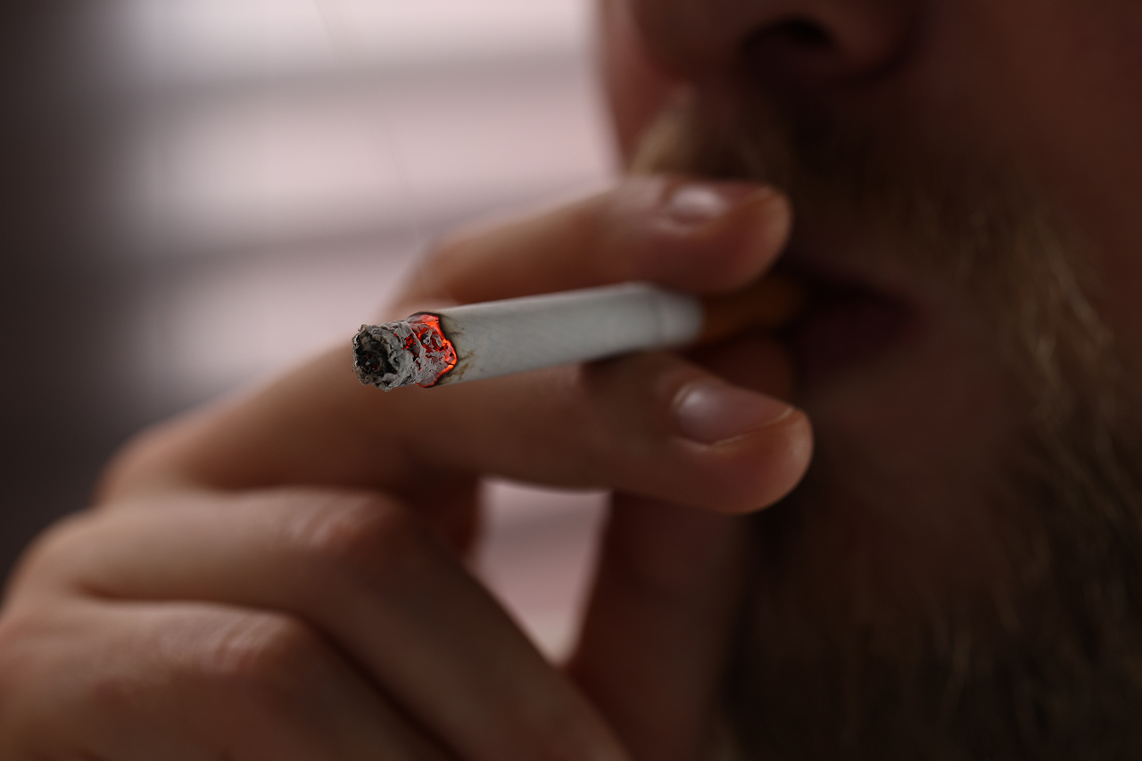 extreme-close-up-of-a-man-smoking-a-lit-cigarette