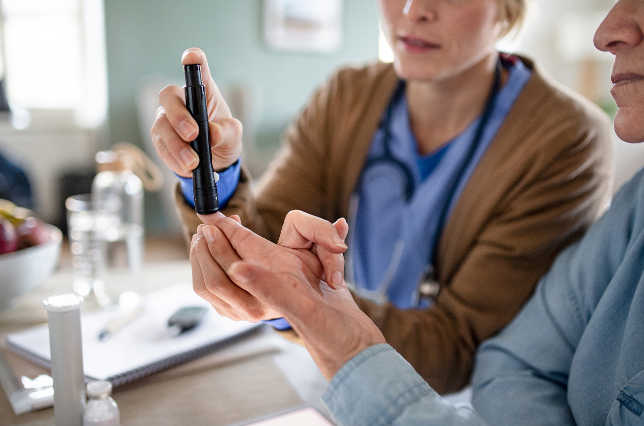 medical-professional-checking-blood-sugar-of-senior