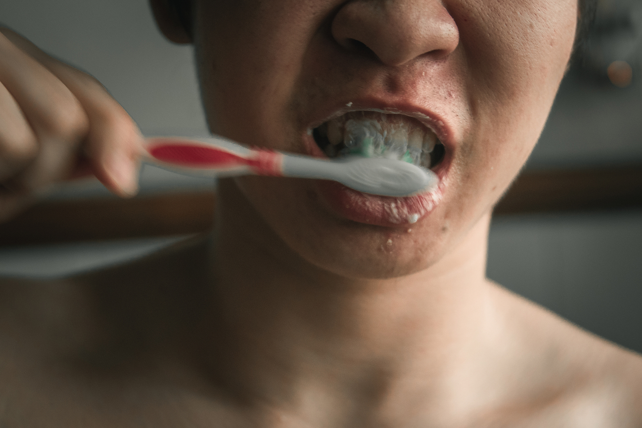 person-brushing-teeth-in-a-brightly-lit-room